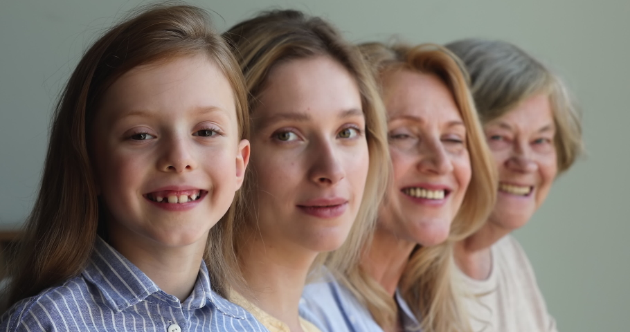 Closeup portrait happy faces of intergenerational dynasty small girl daughter young mother aged grandma mature great granny. Female in 4 different periods of life childhood youth maturity retirement Royalty-Free Stock Footage #1082777056
