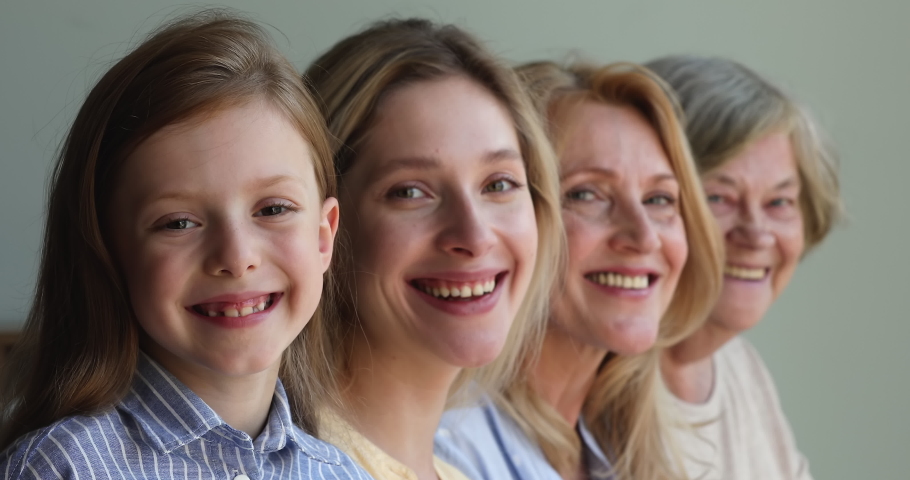Closeup portrait happy faces of intergenerational dynasty small girl daughter young mother aged grandma mature great granny. Female in 4 different periods of life childhood youth maturity retirement Royalty-Free Stock Footage #1082777056