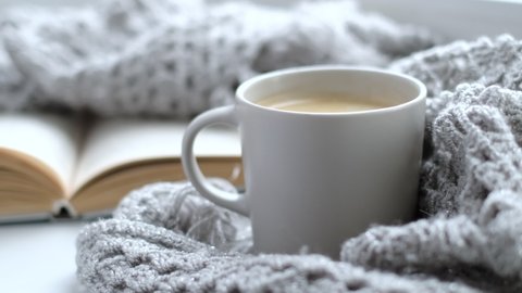 Close up video. Steaming coffee cup on a rainy day window background. cozy atmosphere, in cold weather calm background. Rainy Day Mood. selective focus, soft focus