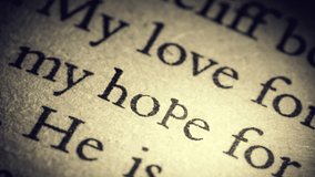The word Hope on an old page in the book is separated from the general text and zooms into the camera. Creative 3D 4k slow motion video animation.