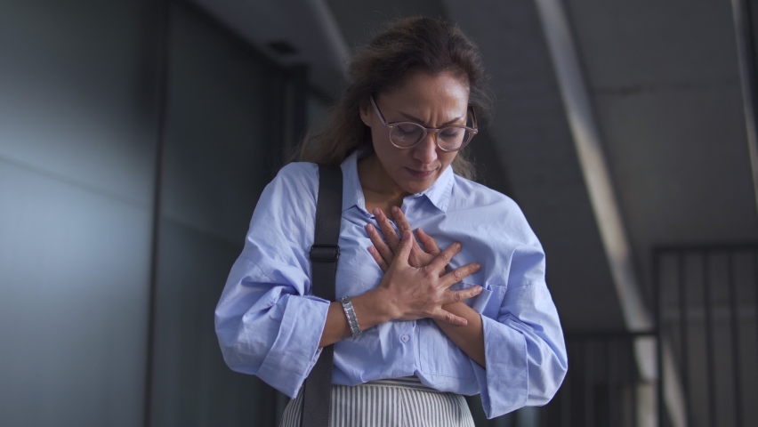 African american woman feeling pain in chest, risk of heart attack, arrhythmia | Shutterstock HD Video #1082780275