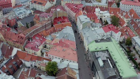 Aerial view Tallinn Estonia. Drone flying over the red roofs of historic buildings and streets in the city center.