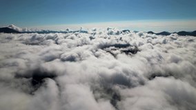 Flying through the ocean of clouds. Top cinematic aerial video. Amazing thick fluffy clouds. Cockpit direct view. Magic fly through the sky. Above the clouds