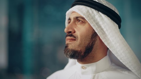 Portrait of Successful Muslim Businessman in Traditional Outfit Gently Smiling, Wearing White Kandura and Black Agal Keeping a Ghutra in Place. Saudi, Emirati, Arab Businessman Concept.