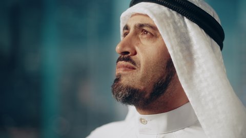 Portrait of Successful Arab Businessman in Traditional Outfit Gently Smiling, Wearing White Kandura and Black Agal Keeping a Ghutra in Place. Saudi, Emirati, Arab Businessman Concept.