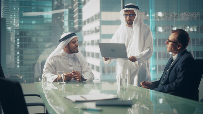 International Business Consultant Advises on Financial Strategy Plan to Successful Arab Company Owners. Multicultural Meeting in Modern Office Between American and Saudi Businessman. Royalty-Free Stock Footage #1082792215