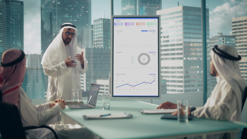 Emirati Businessman Holds Meeting Presentation for a Business Partners. Arab Manager Uses Digital Whiteboard with Growth Analysis, Charts, Statistics and Data. Saudi, Emirati, Arab Office Concept. Royalty-Free Stock Footage #1082792242