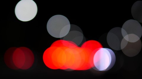 Vehicle headlights and traffic lights blurred bokeh abstract background