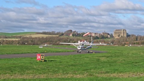 Shoreham, West Sussex, UK, November 21, 2021. Cessna 152 G-BNMF arriving at Brighton City Airport with Lancing College and the South Downs in the background.
