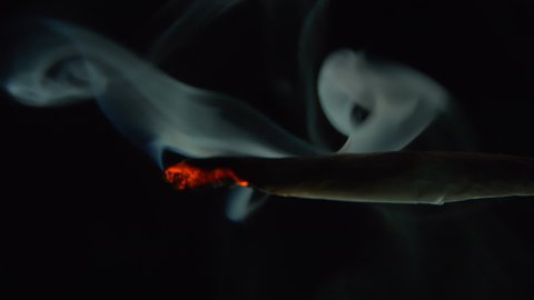 
Burning Marijuana Joint against black