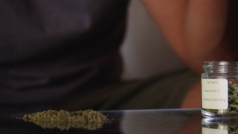 Man rolls joint of marijuana