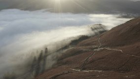 Aerial footage of low cloud over lake at sunrise (Lake District) 