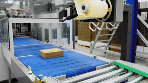 Closer look at automated packaging equipment; labels put on boxes