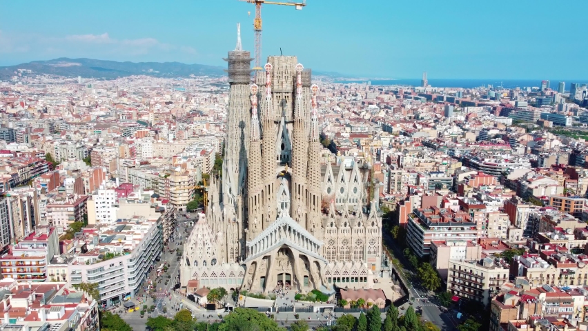 La Sagrada Familia in Barcelona. Panoramic aerial view with the city and the sea in the background | Shutterstock HD Video #1082813692