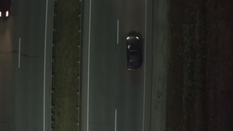 dark gray a dark gray car randomly changes the track along the road. dangerous situation on the road, drunk driving. emergency driving, driving without a driver's license. 4k aerial view 