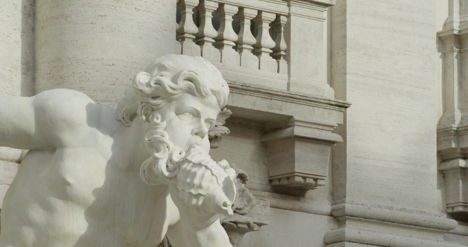 Panning left shot: Detail of a sculpture of the Trevi fountain in Rome. Slow motion 50fps 4k