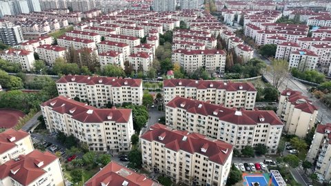 Drone aerial view of Rows of houses with red rooftop Shanghai China. Real estate, economy, business concept b-roll footage. Dense living environments. Traditional Chinese neighborhood and community