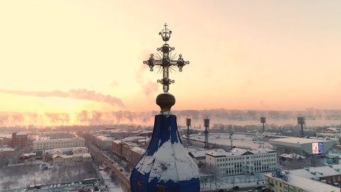 Russia, Irkutsk - January 20, 2021; Holy Cross Church in Irkutsk. Aerial drone flight. Tourist hotels and restaurants. In winter, the Russian city is covered with ice and snow.