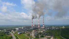 Aerial video. Slowmotion shot of a coal electric plant. Smoke coming out of three pipes of an old electric plant. Carbon emissions concept. Reduce CO2 emissions. Paris agreement. Developing countries