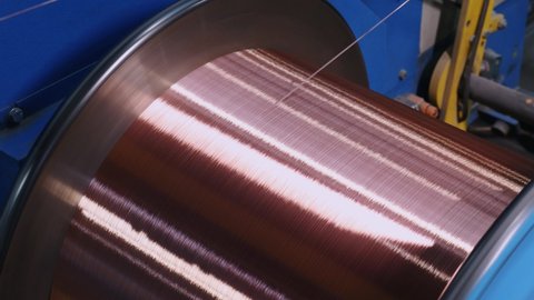 Spinning coil with copper cable close-up. wire production. Copper cable on a reel close-up