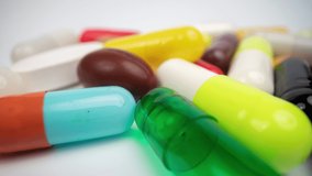 A macro shot of a collection of medicine pills and tablets with a crazy jittery glitching frame effect psychiatric  - Powered by Shutterstock - Get 15% off with code: PIKWIZARD15