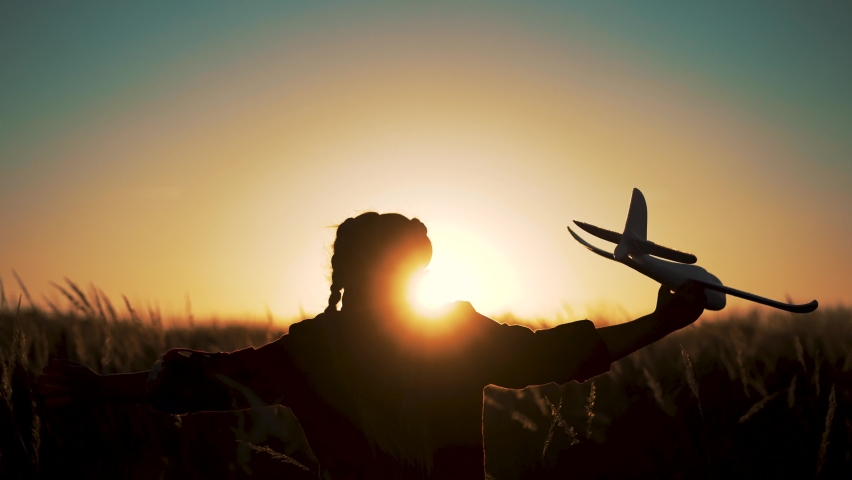 Happy girl with oy in natural park. Child runs on grass with an airplane. Chidhood dream. Happy baby girl with toy airplane at sunset. Child runs on grass in field. Dream travel concept Royalty-Free Stock Footage #1082842249
