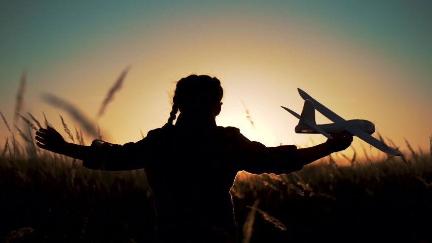 Happy girl with oy in natural park. Child runs on grass with an airplane. Chidhood dream. Happy baby girl with toy airplane at sunset. Child runs on grass in field. Dream travel concept | Shutterstock HD Video #1082842249