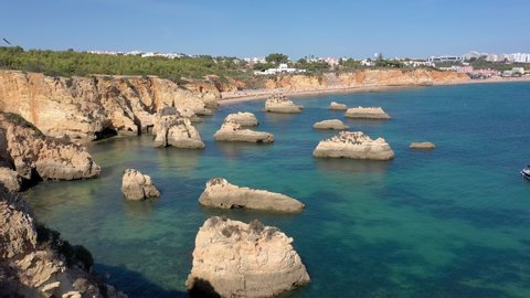 Delightful aerial view of Portuguese rocky beaches near the city of Portimao. For the rest of tourists. Algarve.