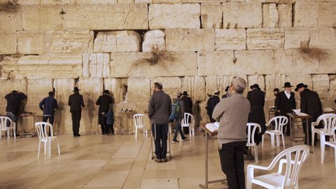 Jerusalem, Israel – Nov 22, 2021: Orthodox Jews praying together in Western Wall,  Wailing Wall, Kotel in Jerusalem. Religious Jews praying in Jerusalem's western wall. The most sacred place for jews