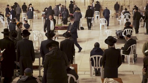 Jerusalem, Israel – Nov 22, 2021:  Jews Manh religious jews praying together in Western Wall,  Wailing Wall, Kotel in Jerusalem. Religious Jews praying in Jerusalem's western wall.  Orthodox jews