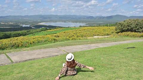 Tourist woman feeling relax while looking to beautiful natural view in Mae Moh power plant located in Mae Moh district, Lampang province, Thailand.