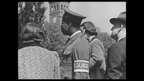 1940s: Caption discusses work opportunities for students. Tour guide speaks to group on college campus. Man makes notes in ledger. Man mows lawn. Woman serves food.
