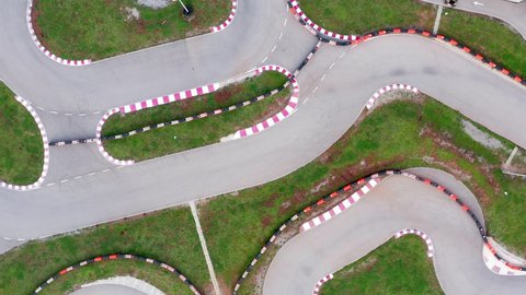 Kart circuit - race track for go cart, motorcycle, bike or radio-controlled model racing. Aerial drone top view of the raceway or speedway route with curves.