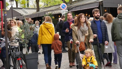PARIS, FRANCE - 30 OCTOBER 2021: Crowd of People Pedestrians on a Street of Montmartre in Paris, October 2021