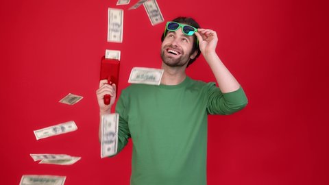 Millennial guy shoot air dollars income gun isolated shine color background