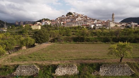 Lateral and descending drone flight of Peñarroya de Tastavins Village in Matarraña Region in Spain