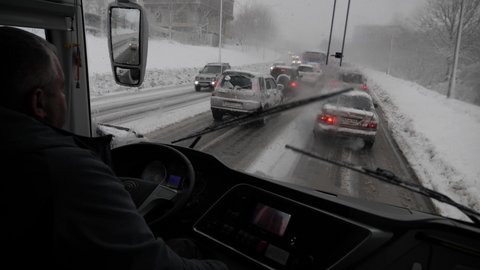 Petropavlovsk, Russia - Nov 21 21: Traffic on the snowy and frozen road in Petropavlovsk Kamchatsky, Kamchatka, Russia during a winter.