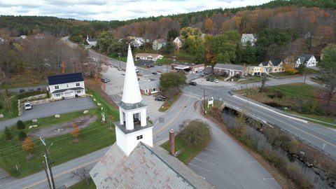 United Methodist Church, Landmark of Sunapee, New Hampshire USA. Aerial View of Tower, Roads and Colorful Autumn Foliage, Drone Shot
