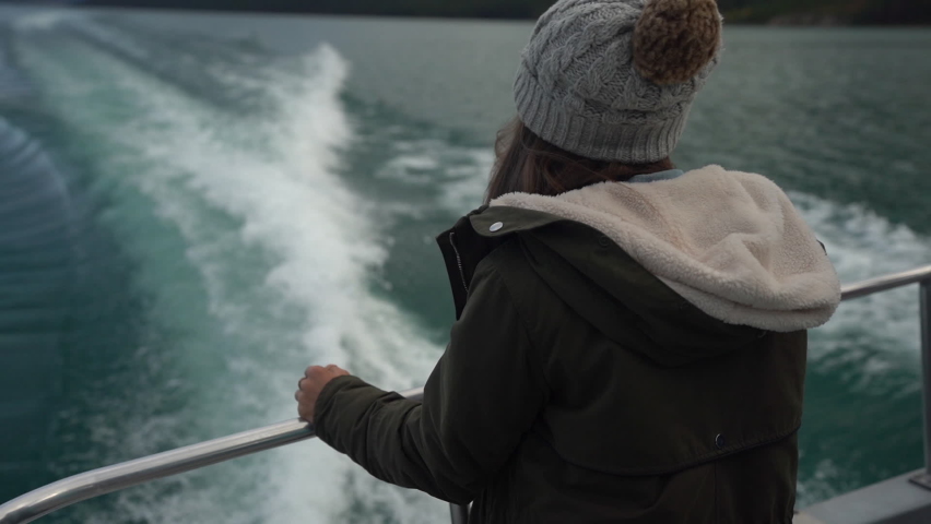 Female on Back of Ferry Boat Looking at Water Wakes and Scenic Coastline of Lake Maligne, Jasper National Park, Canada, Cinematic Full Frame Shot