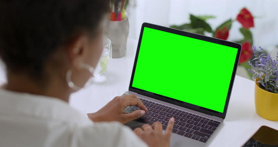 
Over the Shoulder Shot of African American Business Woman Typing on Laptop, Young Female Professional Writing an Important Email From Her Home in Modern Living Room. Remote Working. Green Screen. Royalty-Free Stock Footage #1082868169