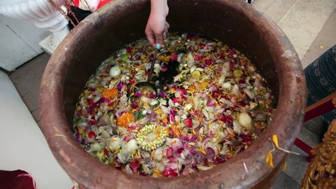 Spring, 2018 - Bangkok, Thailand - Celebrating Songkran Thai New Year. Close-up. A ritual bowl with a herbal infusion for pouring over Buddhist deities.