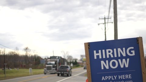 Help Wanted sign hanging by side of a rural West Virginia road in autumn.