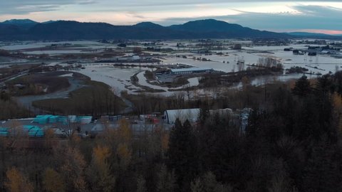 Aerial view of Fraser Valley farmers fields flooded from torrential rains, climate change effect, natural disaster, intense flooding, British Columbia. 4K 24FPS