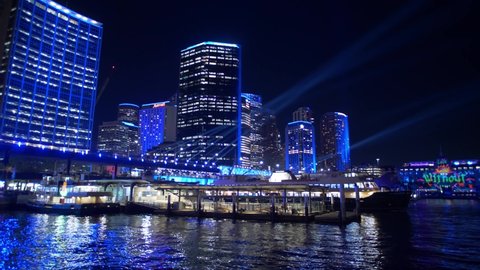 SYDNEY, NSW, AUSTRALIA. JUNE 11 2019. Circular Quay and Sydney skyscrapers in blue neon light.