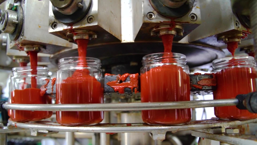 Automatic Line for Processing of Vegetables. Glass jars with vegetables pasta on conveyor belt. Bottling Tomato Paste in Glass jars. | Shutterstock HD Video #1082881432