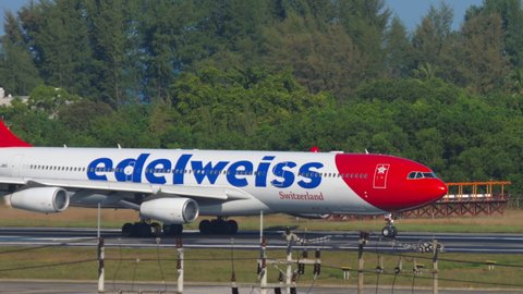PHUKET, THAILAND - DECEMBER 02, 2018: Airbus A340, HB-JMG of Edelweiss Air take off speed from Phuket Airport (HKT). Tourism and travel concept. Airport on a tropical island