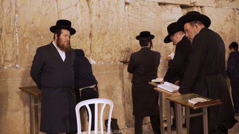 Jerusalem, Israel – Nov 22, 2021: Group of religious Orthodox Jews praying together in Western Wall,  Wailing Wall, Kotel in Jerusalem. Religious Jews praying in Jerusalem's western wall. Torah study
