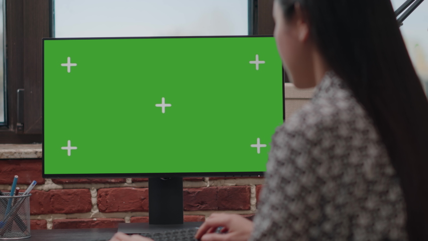 Close up of worker using computer with horizontal green screen in company office. Business woman working with isolated template and mockup background on chroma key monitor. Startup employee Royalty-Free Stock Footage #1082888530