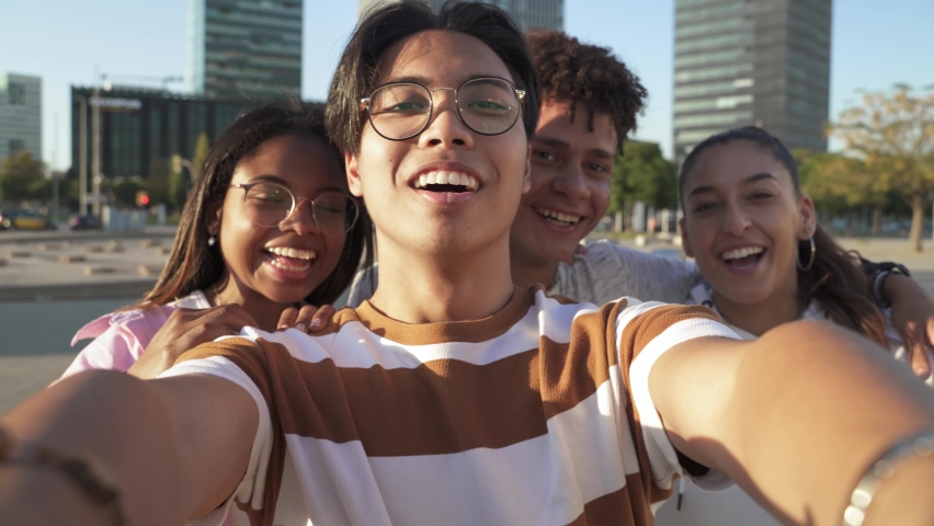 Asian Boy is Taking a Selfie or making video call with happy Multiethnic Teenager friends together in the city Royalty-Free Stock Footage #1082893672
