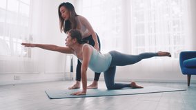 Pregnant woman doing Pilates exercise with personal trainer at home. - Powered by Shutterstock - Get 15% off with code: PIKWIZARD15